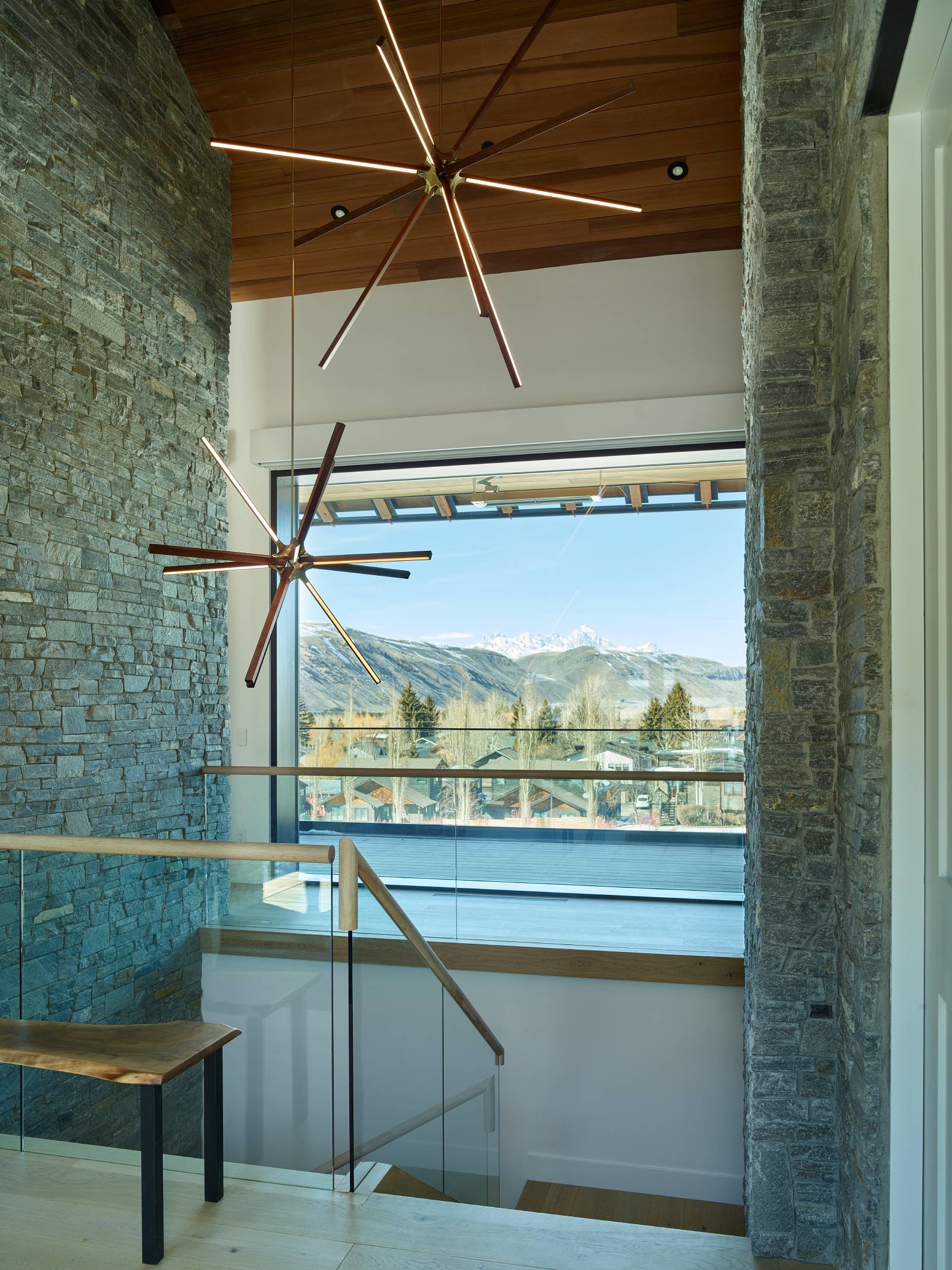 Interior view of the stairwell and picture window at Cache Creek South, a custom home designed and built by Farmer Payne Architects.