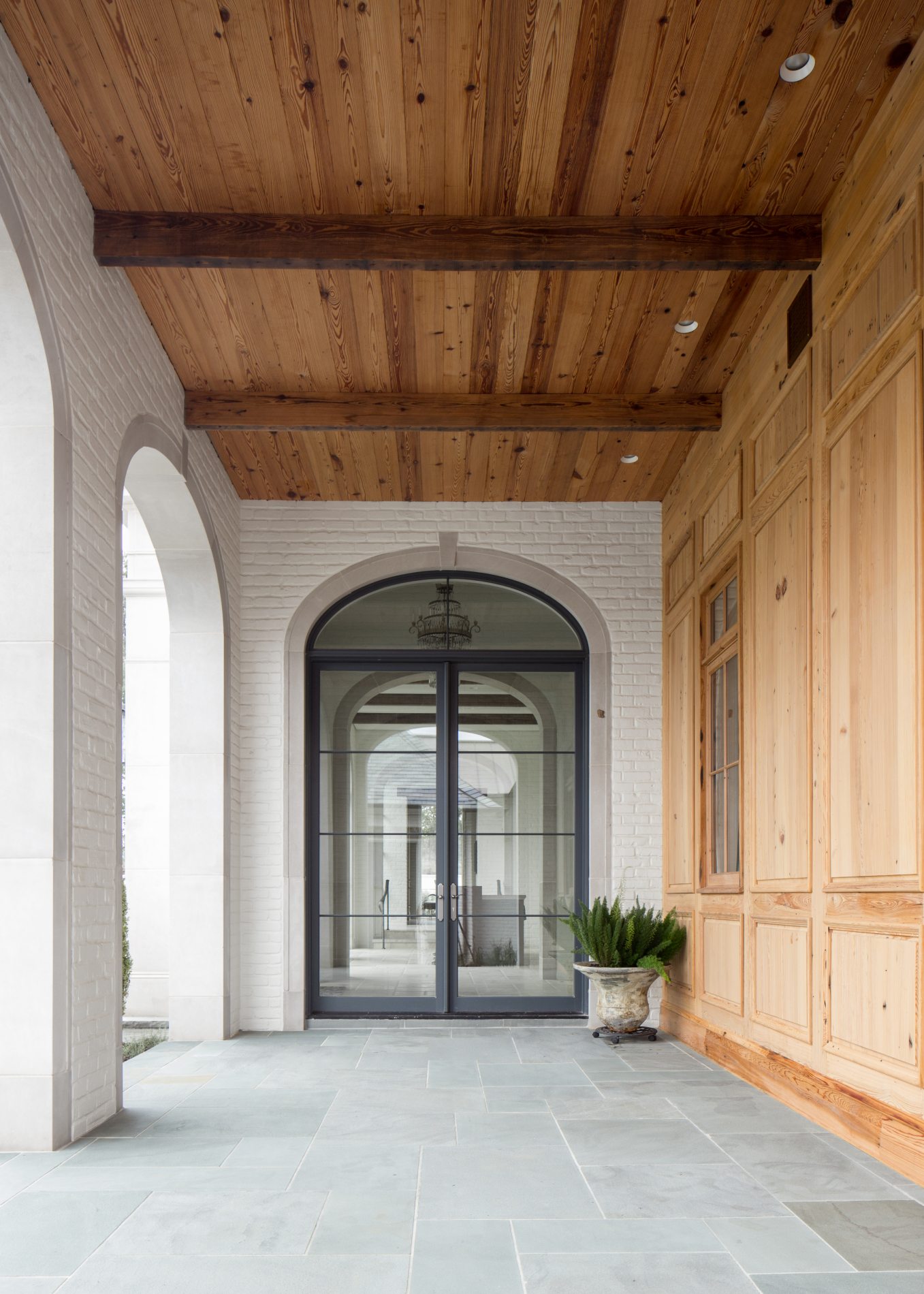 Exterior view of the front porch at French Influential, a custom home designed and built by Farmer Payne Architects.