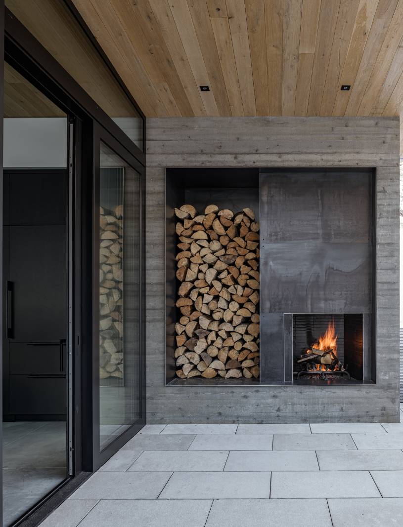 Exterior view of the fireplace at Avalanche Chalet, a custom home designed and built by Farmer Payne Architects.