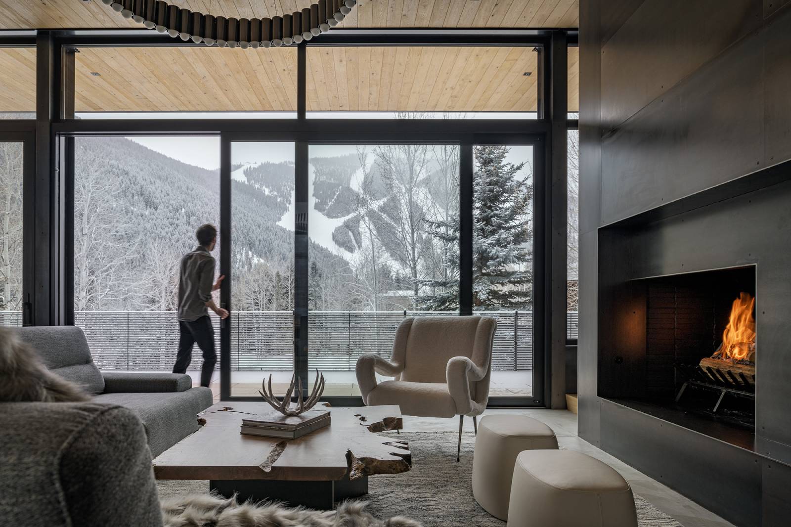 Interior view of the living room and deck at Avalanche Chalet, a custom home designed and built by Farmer Payne Architects.