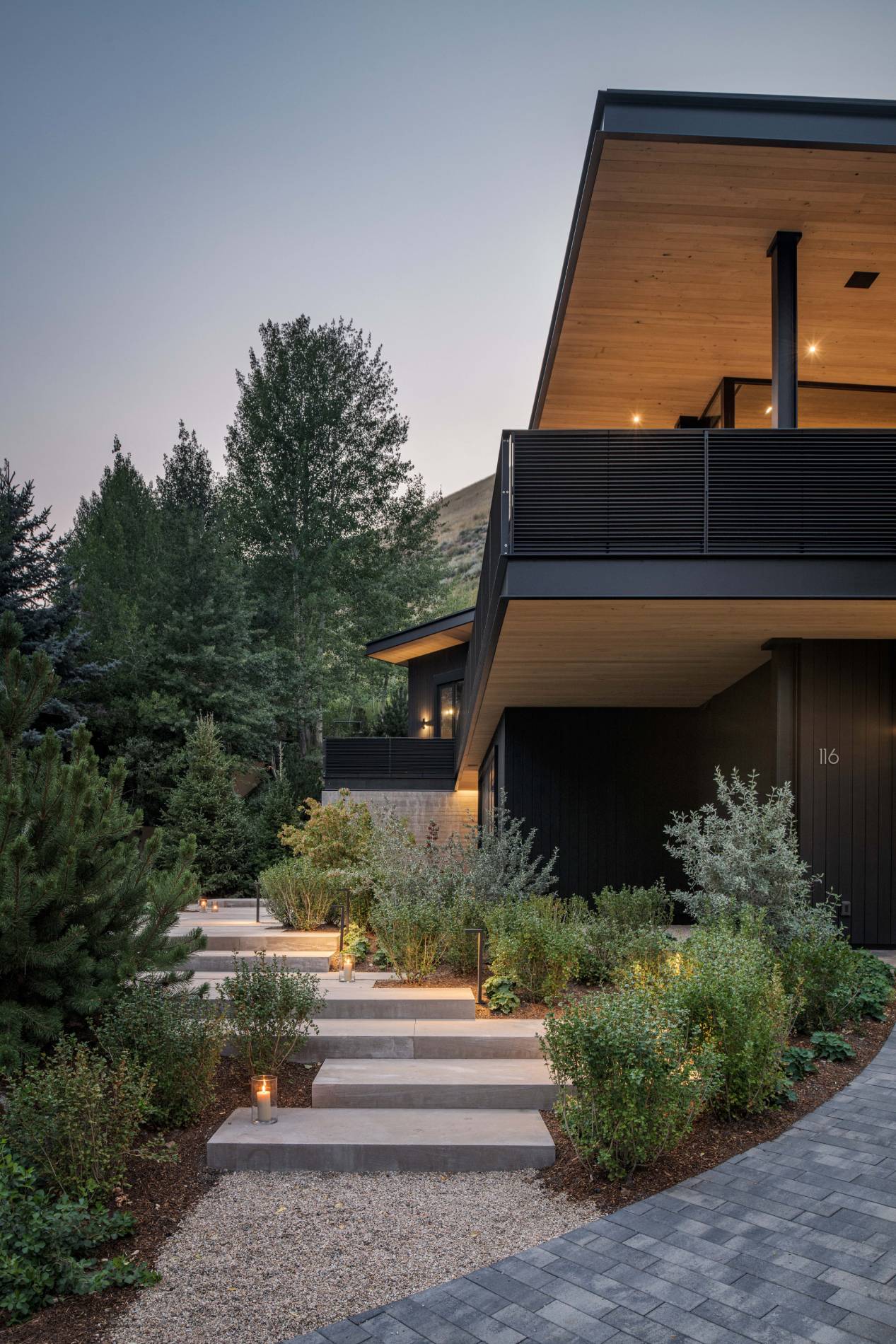 Exterior view of the landscaping and walkway at Avalanche Chalet, a custom home designed and built by Farmer Payne Architects.