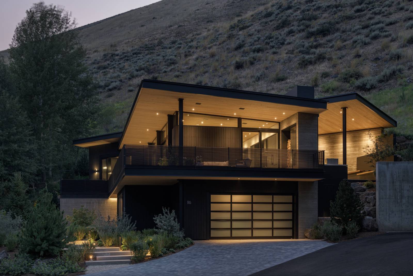 Exterior view of Avalanche Chalet at night, a custom home designed and built by Farmer Payne Architects.