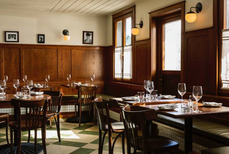 Interior view of the dining area with wood wainscoting at Glorietta Trattoria restaurant, a custom renovation project designed by Farmer Payne Architects.
