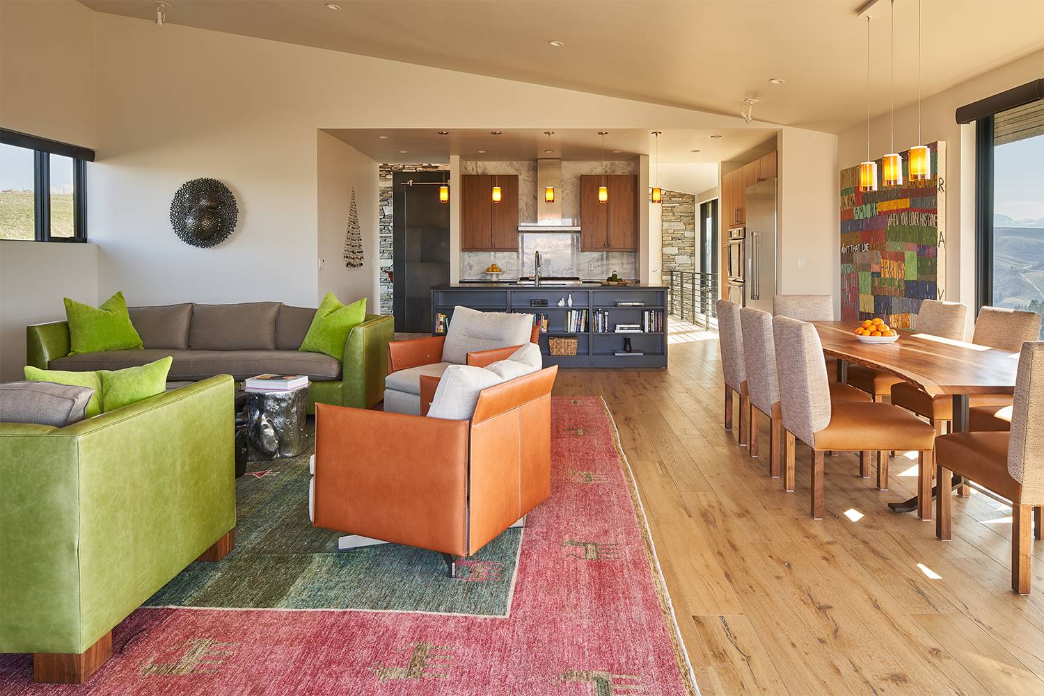 Interior view of the open-plan living room, dining room, and kitchen at Gros Ventre West, a custom home designed and built by Farmer Payne Architects.