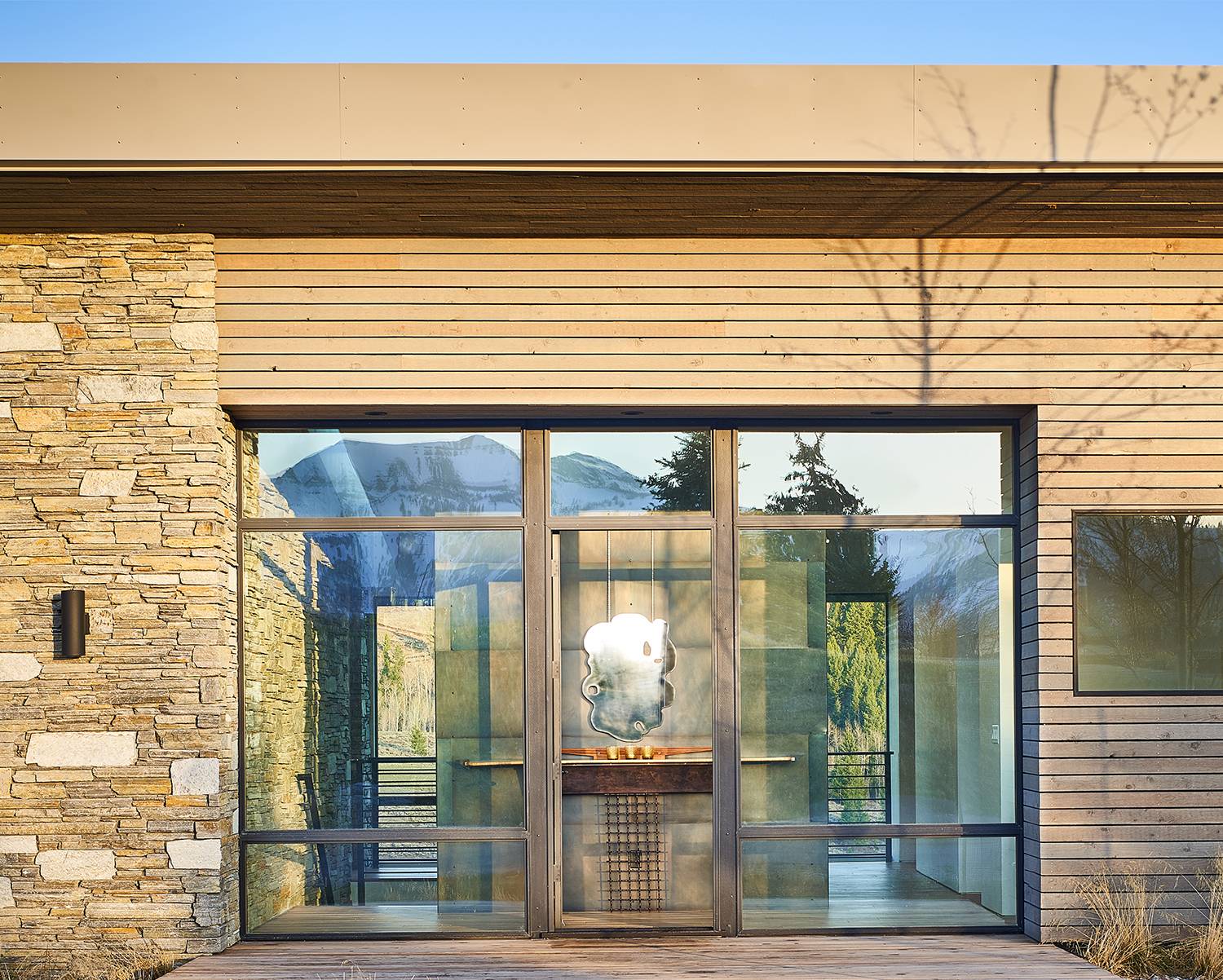 Exterior view of the main entry at Gros Ventre West, a custom home designed and built by Farmer Payne Architects.