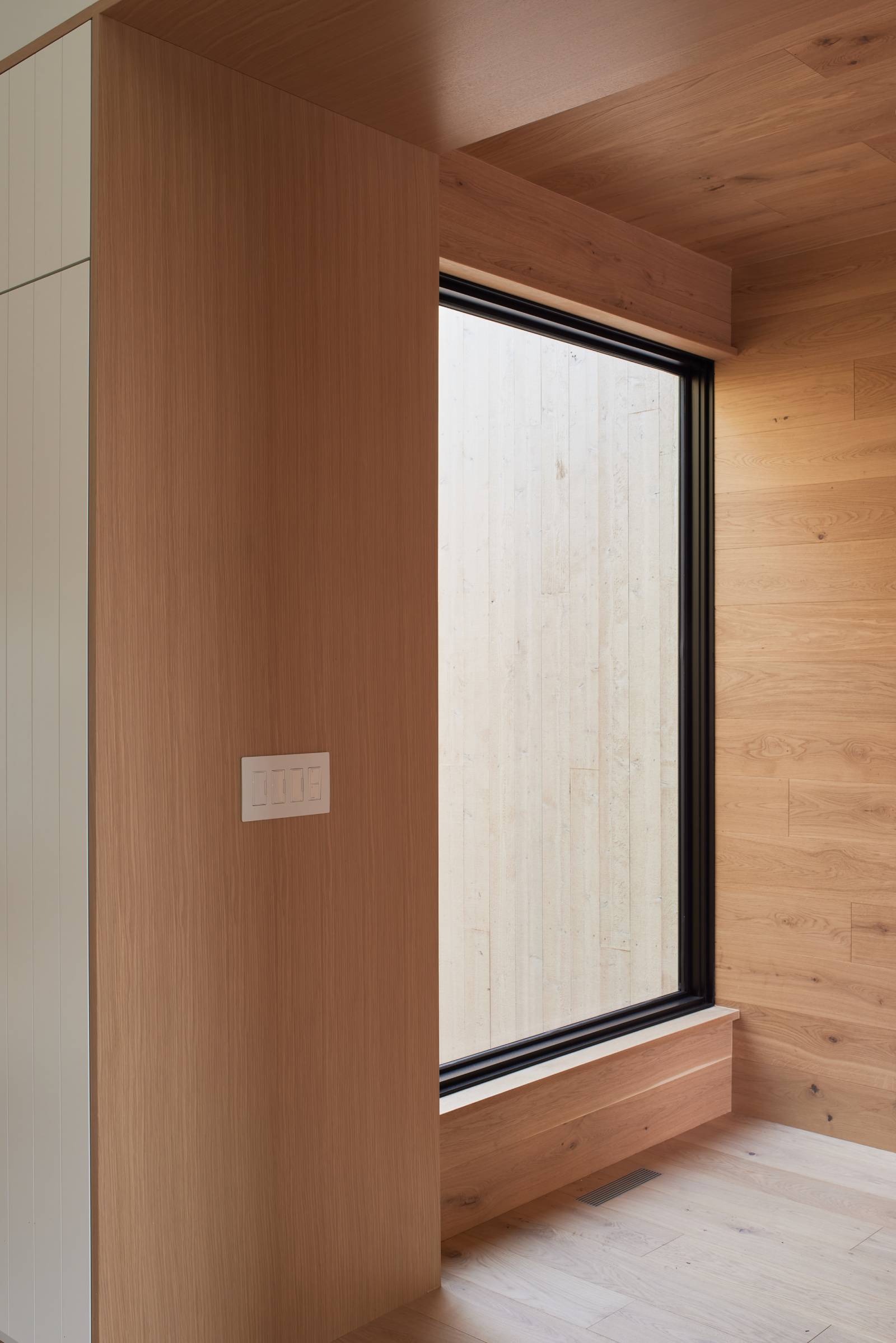 Interior detailed view of a picture window at Double Hansen, a custom duplex designed and built by Farmer Payne Architects.
