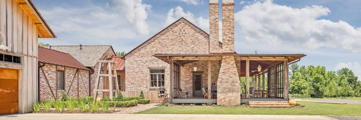 Exterior view of the facade at Louisiana Rustic, a custom home designed and built by Farmer Payne Architects.