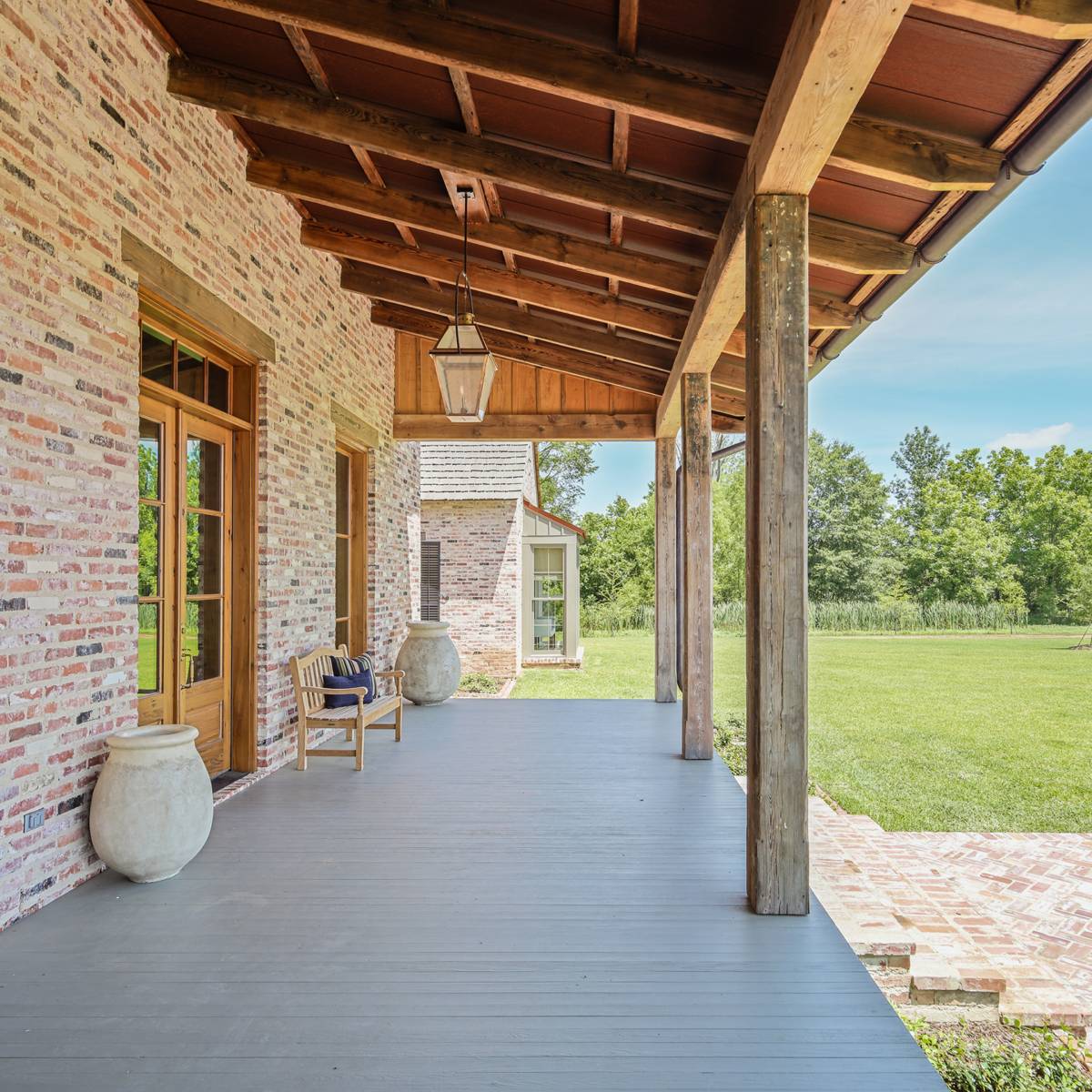Exterior view of the front porch at Louisiana Rustic, a custom home designed and built by Farmer Payne Architects.