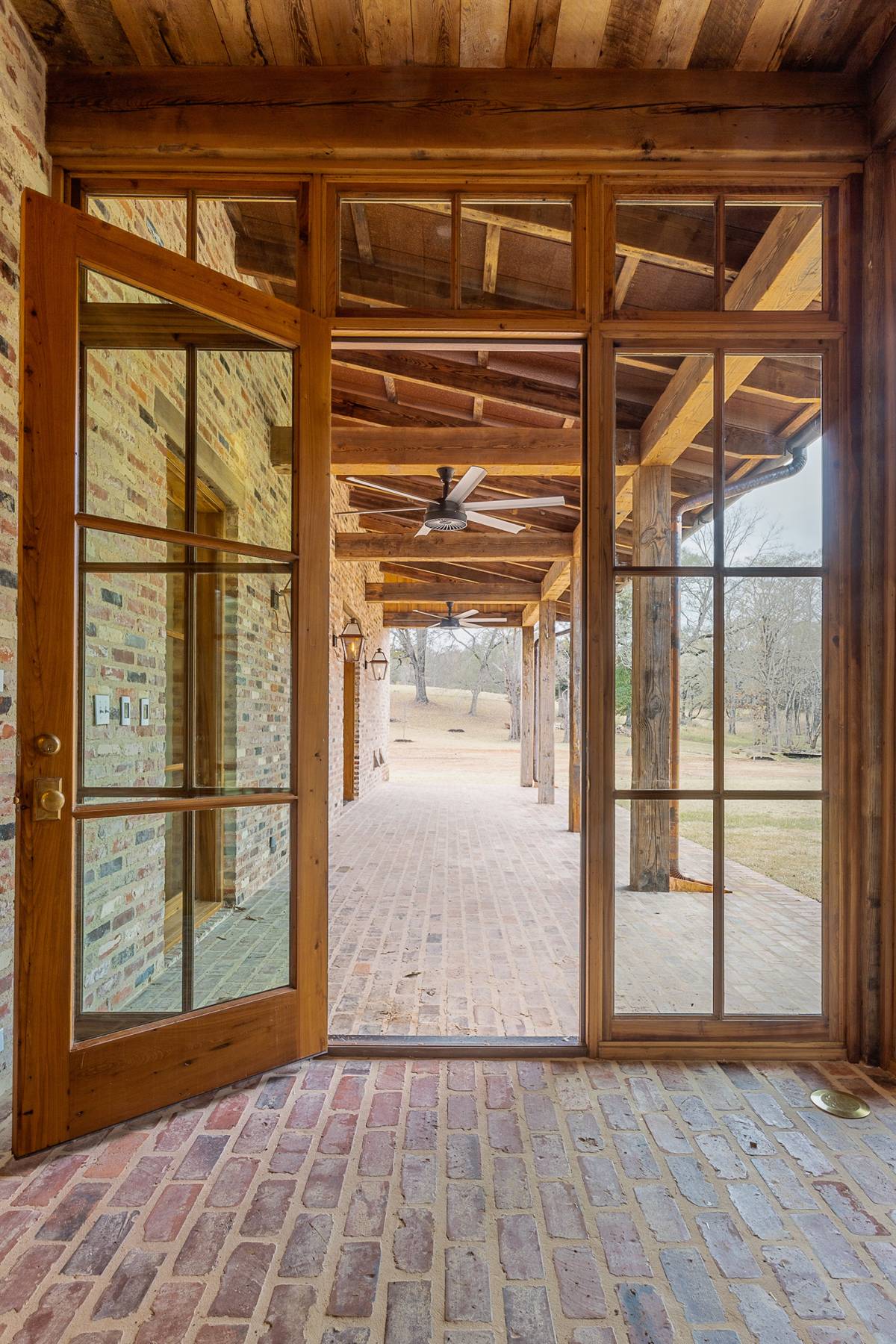 Interior detailed view of a rustic glass door at Louisiana Rustic, a custom home designed and built by Farmer Payne Architects.