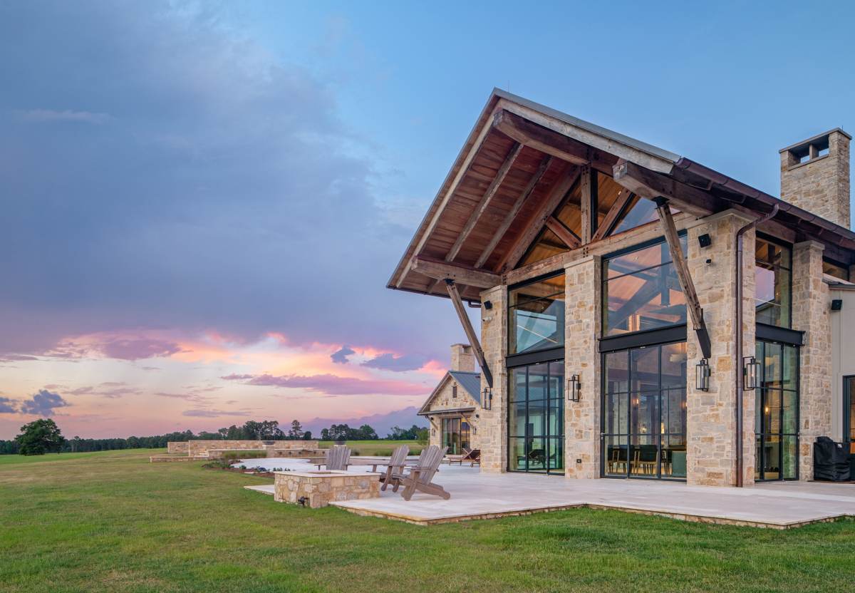 Exterior view of the fireplace and patio at Texas Ranch, a custom home designed and built by Farmer Payne Architects.