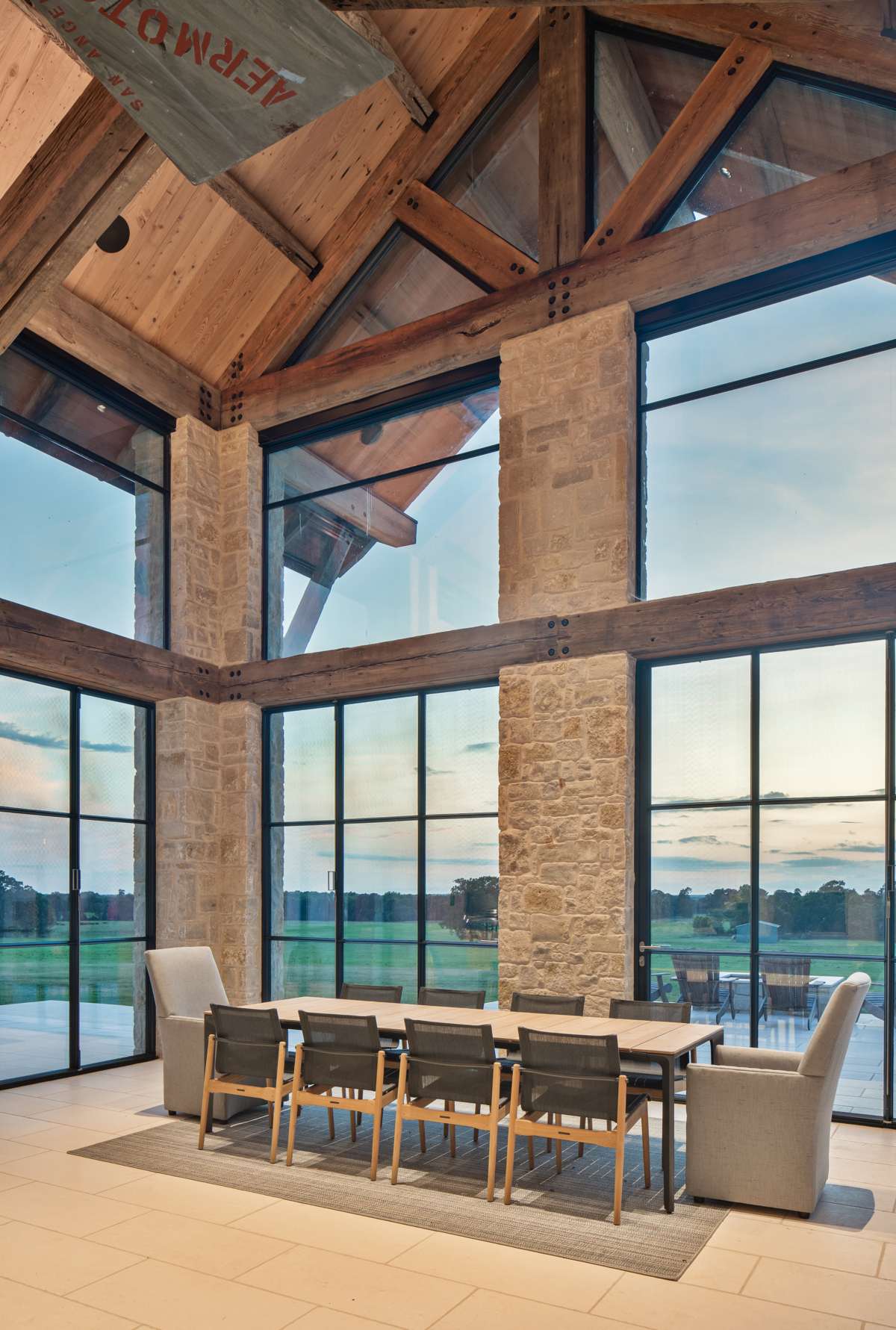 Interior view of the indoor-outdoor dining room at Texas Ranch, a custom home designed and built by Farmer Payne Architects.