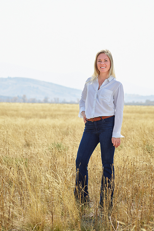Farmer Payne Architects Interior Coordinator Meredith Leonard stands in a field in Jackson Hole.