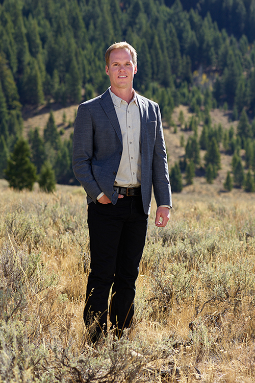 Farmer Payne Architects Co-Founder Scott Payne stands in a field in Jackson Hole.