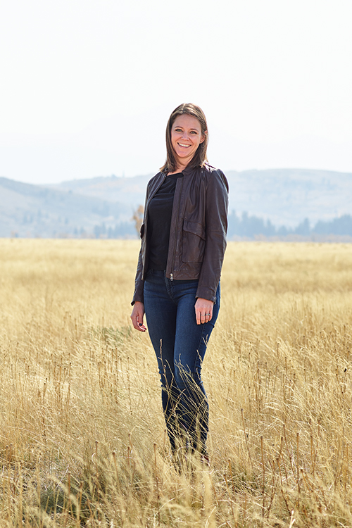 Farmer Payne Architects Studio Manager Tory Hinson stands in a field in Jackson Hole.